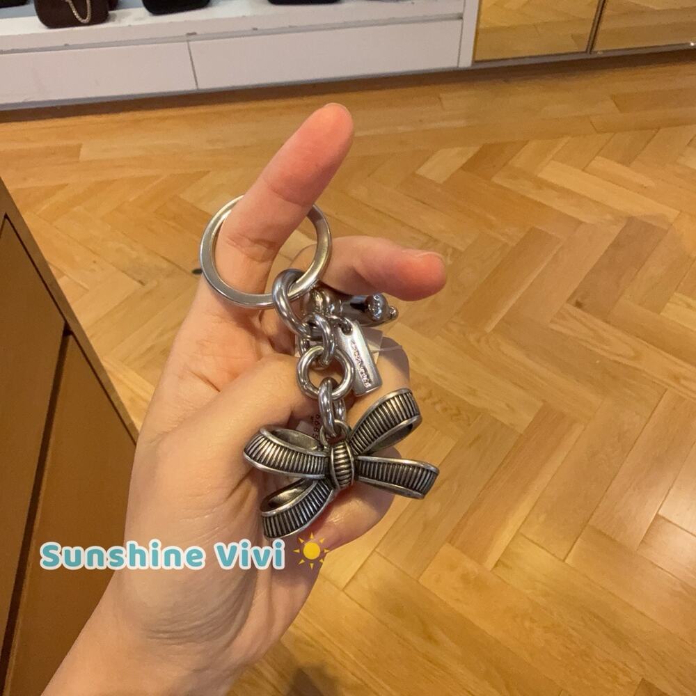 NWT Coach Bow Bag Charm silver /silver CEM83 with Dust bag